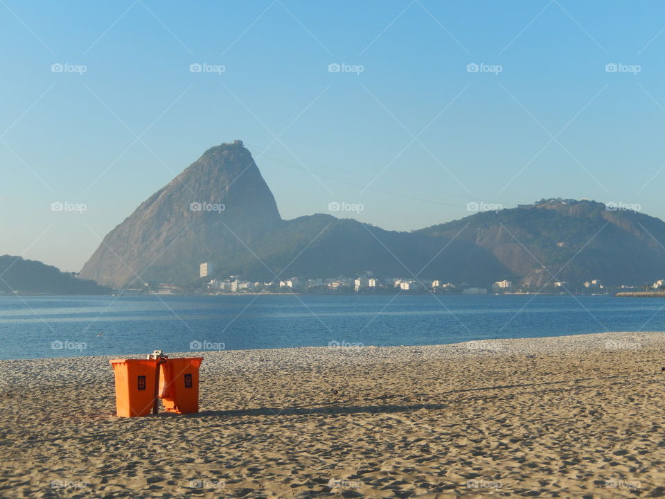 Sugar Loaf. View of Sugar Loaf from Flamengo Beach and a trash can.