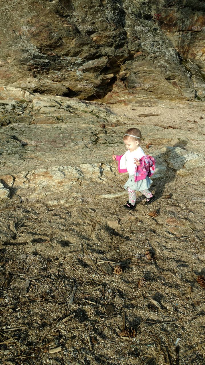 Baby girl walking near mountain