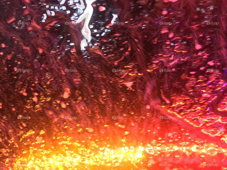 Wet soapy windshield in the car wash 