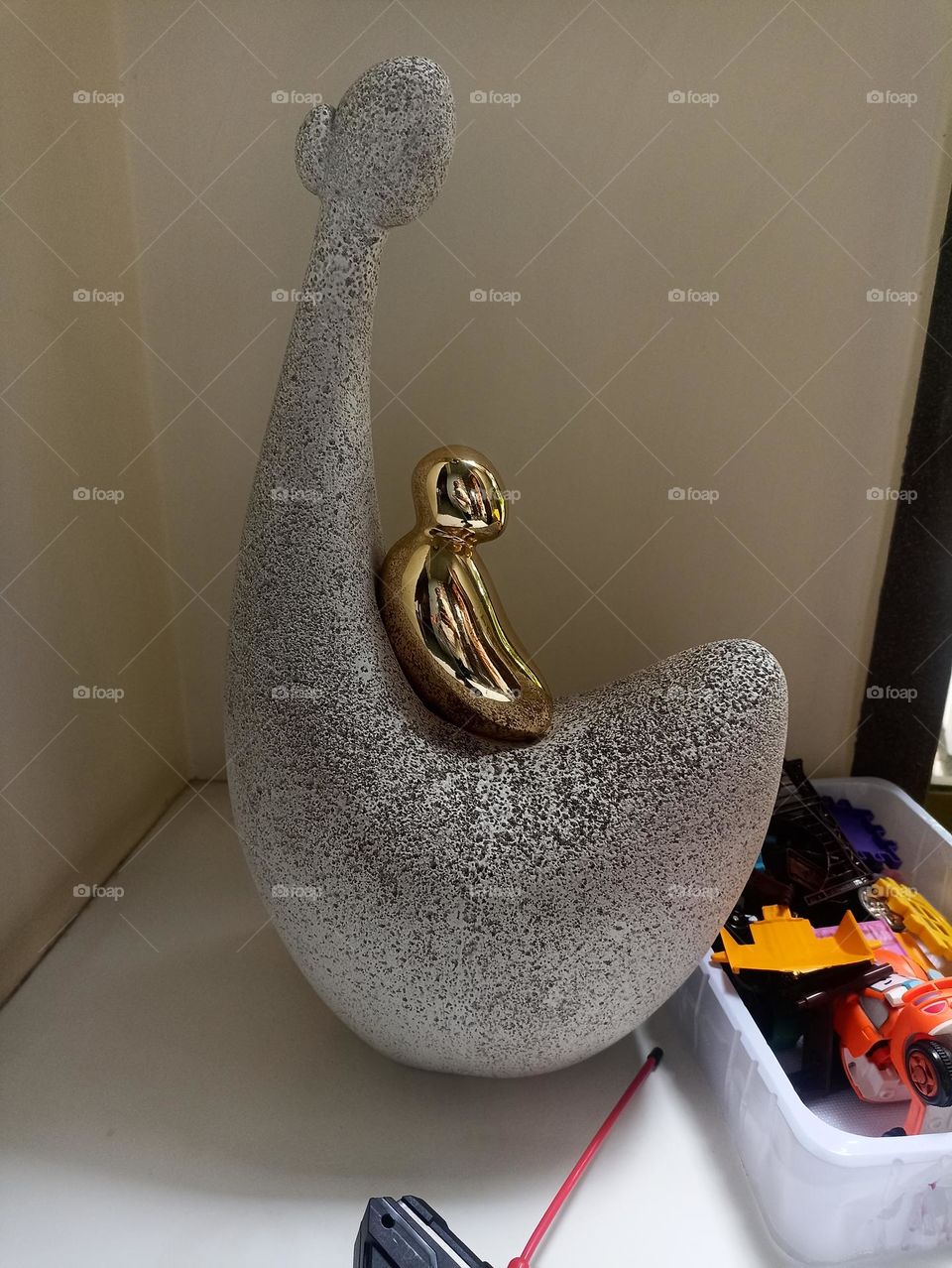 The most beautiful colored statue of a mother with its metal baby on her body.