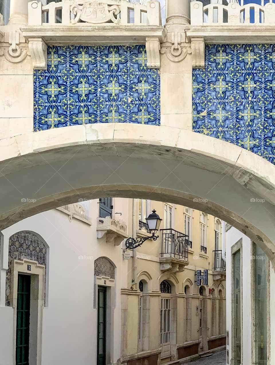 A tiled archway above a traditional street in Leiria, Portugal 