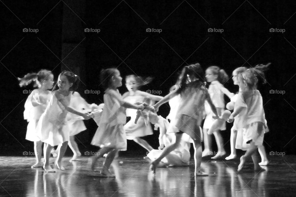 Children’s games in black and white. Little girls make a round. The blur reflects the speed of movement