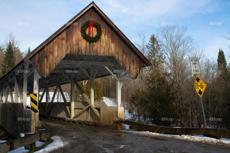 A rustic covered bridge ready for Christmas during winter time in New England 2022.
