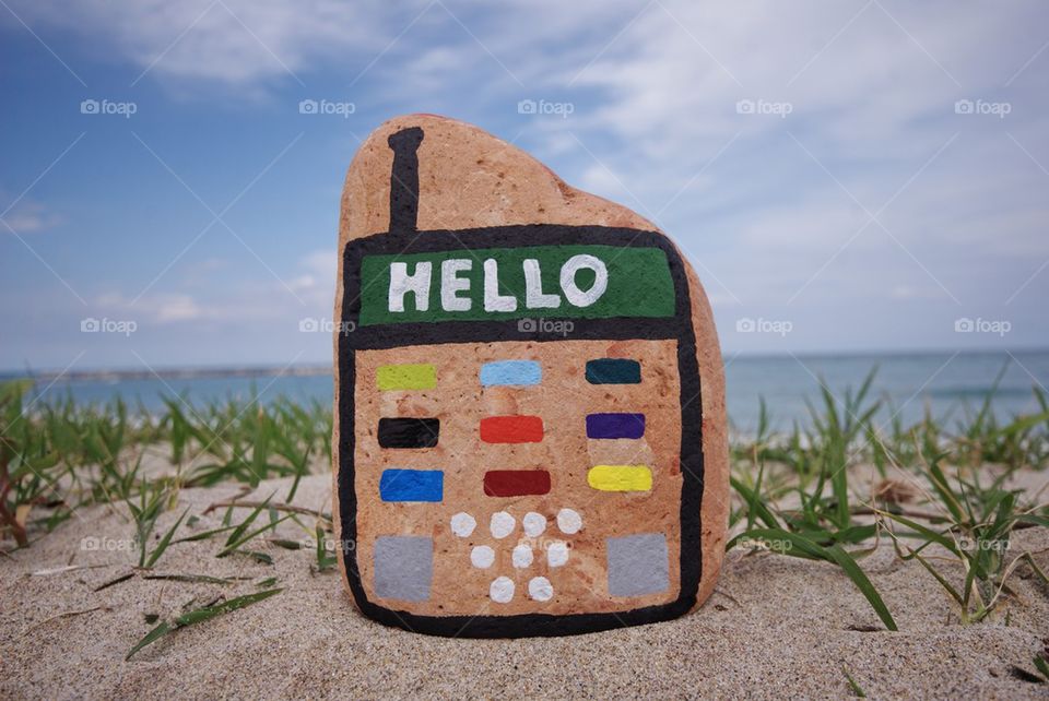 Stone mobile phone with hello message on display