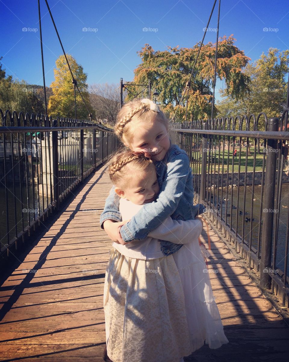 Happy sister standing on pier