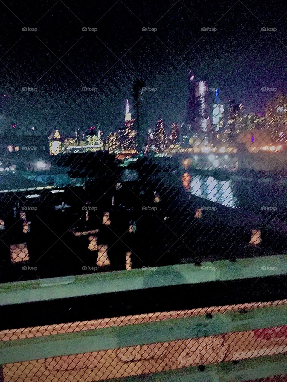 Parts of Greenpoint, Brooklyn, Long Island City, Queens, New York and in the far background the Manhattan skyline and the Empire State Building photographed from the pedestrian walkway of the Pulaski Bridge in October 2020. Hypnotic Productions