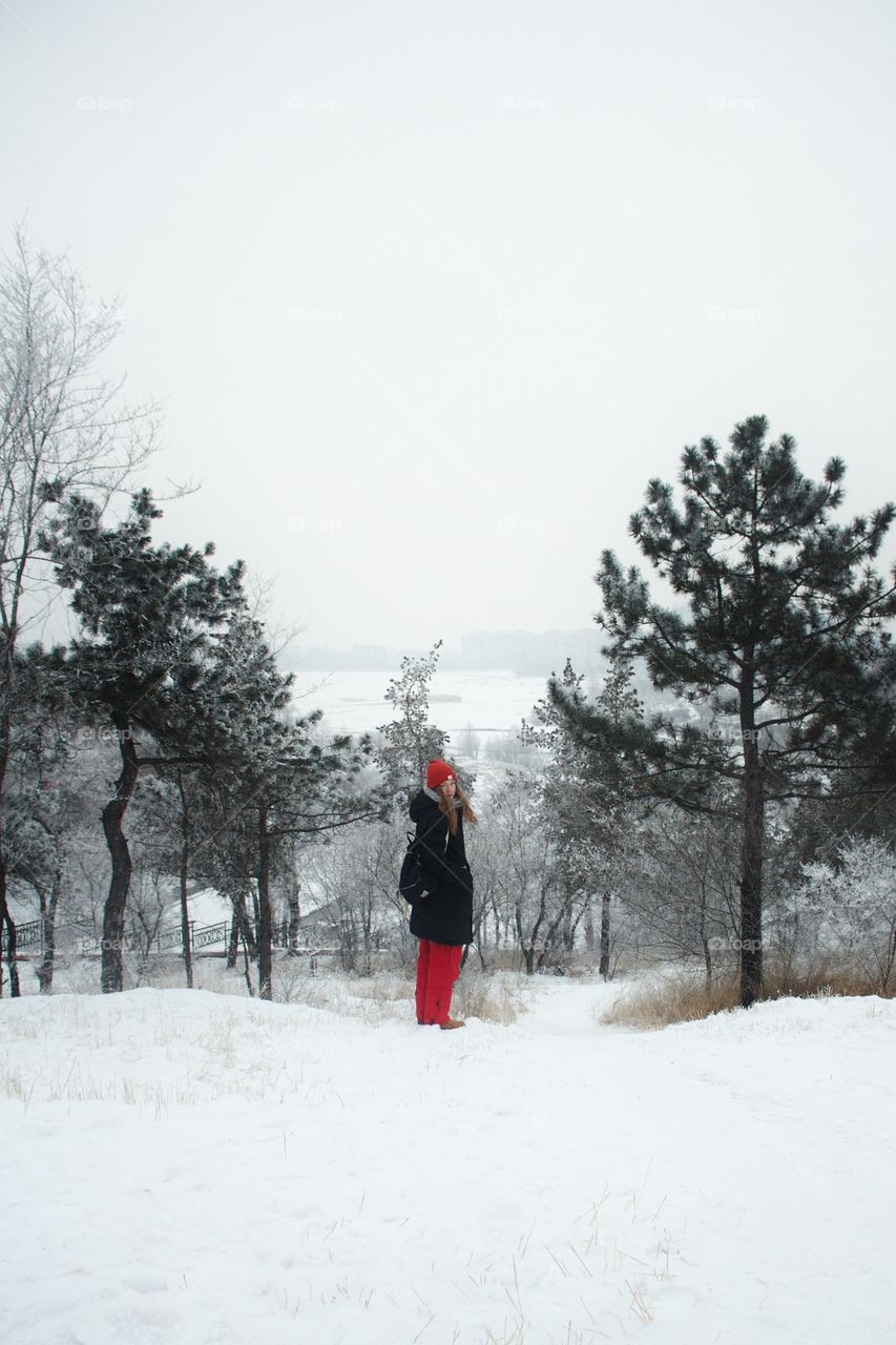 Girl on the slope of a snowy mountain