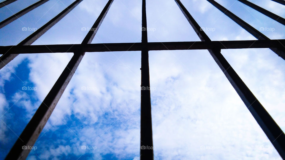 cloud and sky through silhouette window frame