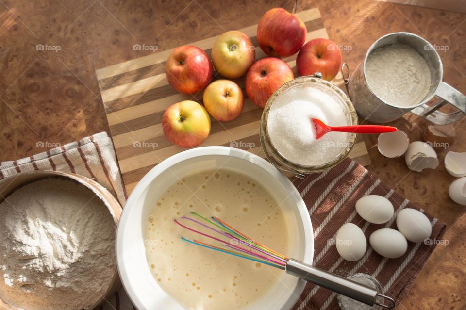 Making homemade puffed apple pie with eggs, sugar and flour.