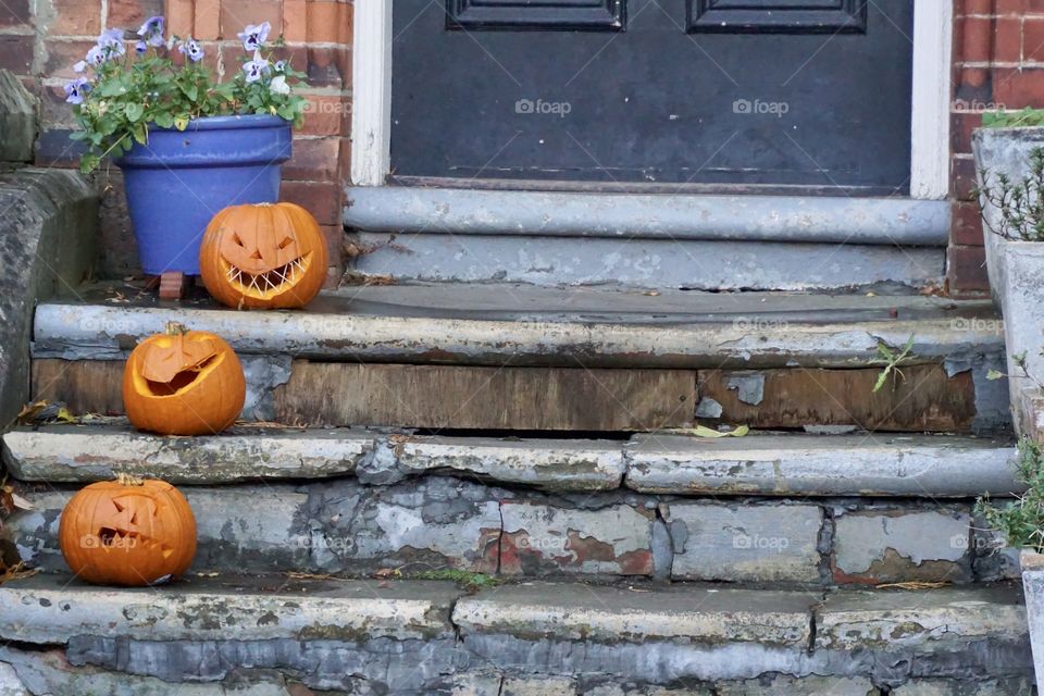 Three little pumpkins on a doorstep 