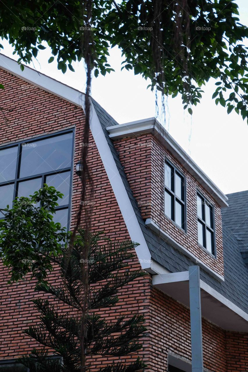 Red brick house with gray roof tiles