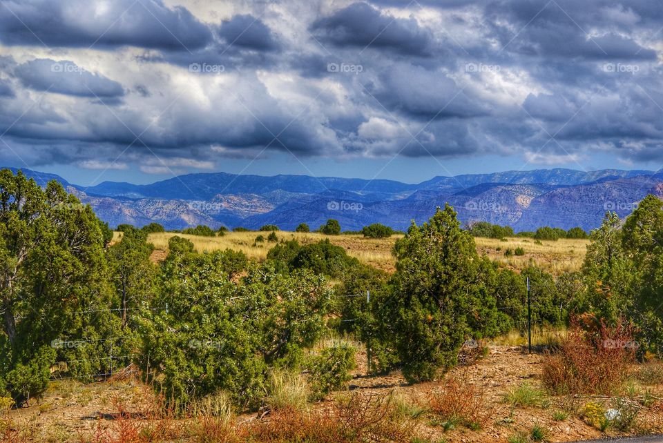 Scenic view of landscape against storm cloud