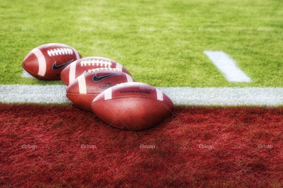 Footballs. Quarterback drills at the stadium. No one but QB equipment and coaches allowed to mess with them before the game. 