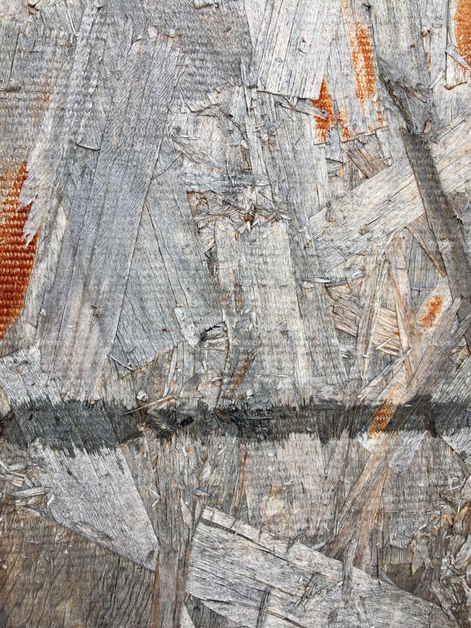 Abstract closeup surface detail of weathered particle board sheeting 