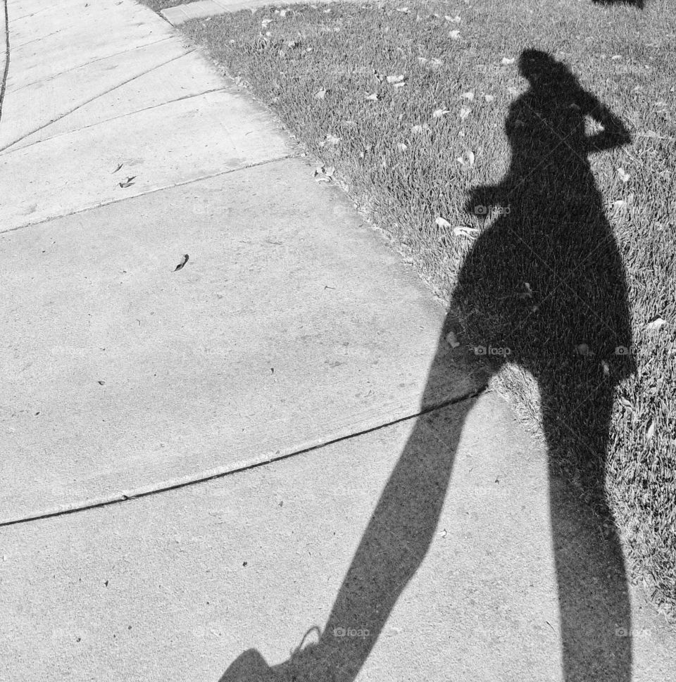 Running shadows. shadow on sidewalk while going on daily run