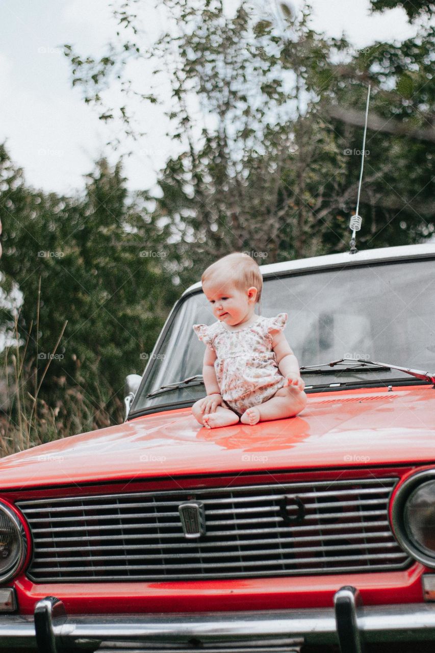 baby on a vintage car
