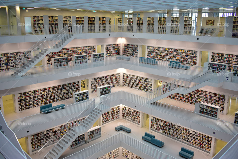 fantastic view in a library: floors, steps, books