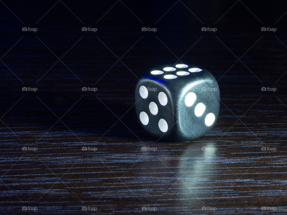 Table gambling with dice in the evening with dim light on a dark background