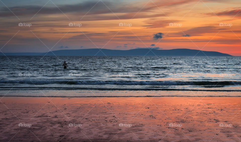 Man in the Atlantic ocean on a new year's day 2020 at Silverstrand beach, Galway, Ireland