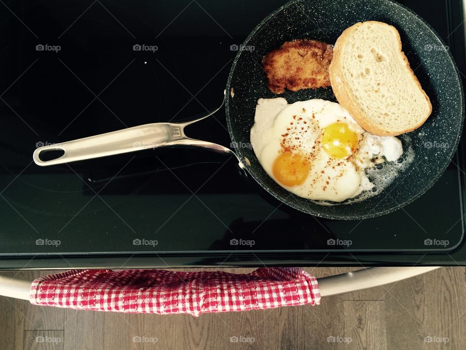 Bread and fried egg in frying pan