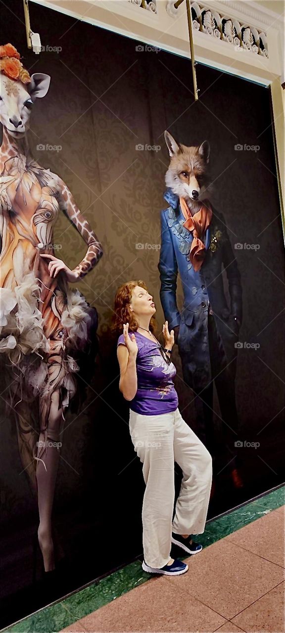 These elegantly attired animal models, a giraffe ballerina and a fox adorn the interior of “das Schloss”, “the Castle”, a popular multistory shopping mall in “Berlin”, capitol of Germany in the “Steglitz” district. 2024. Hypnotic Productions