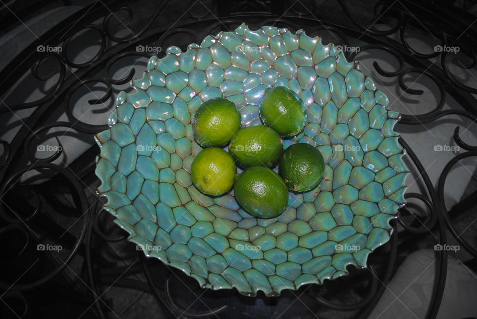 A bowl with limes