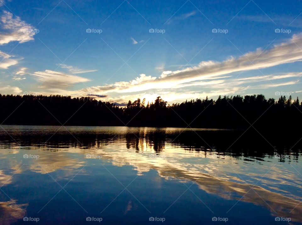 Silhouette of trees and idyllic lake