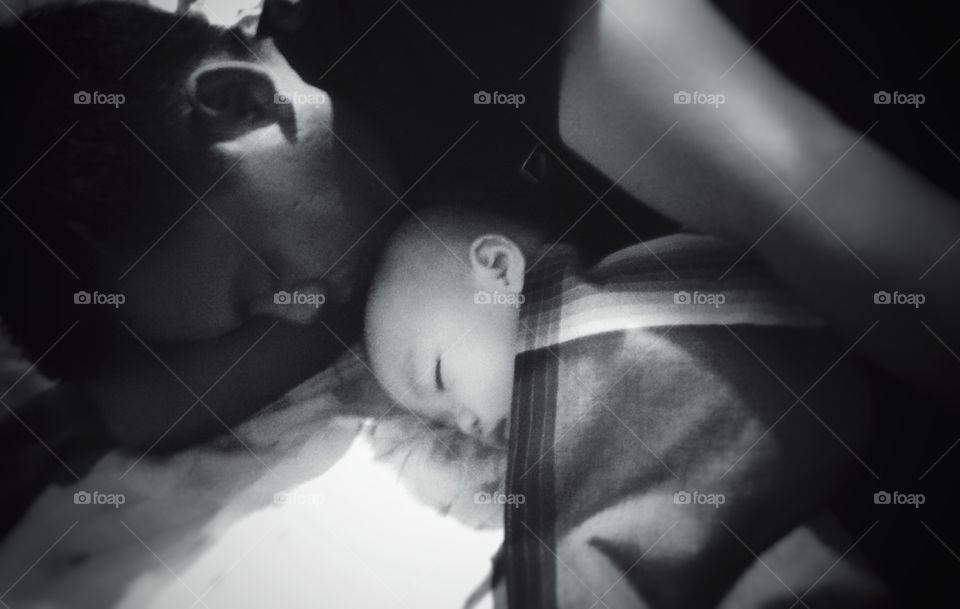 Father sleeping with his baby boy