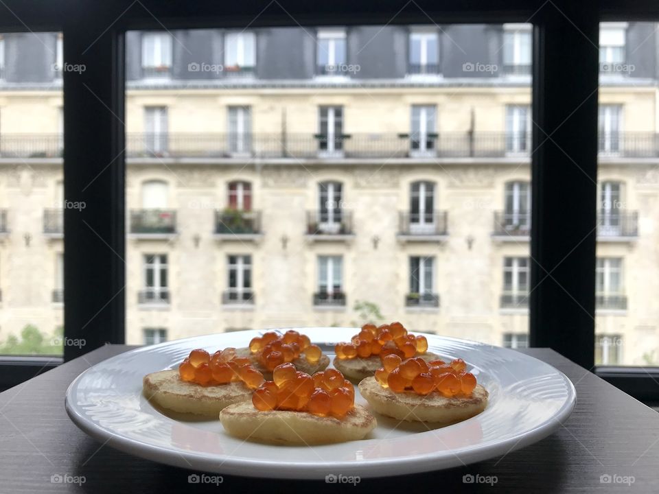 Breakfast in Paris. Traditional Russian pancakes with red salmon caviar 