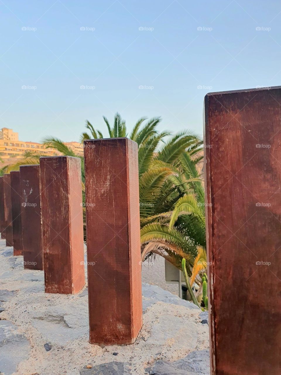 rectangle - brown wooden posts as a wall boundary