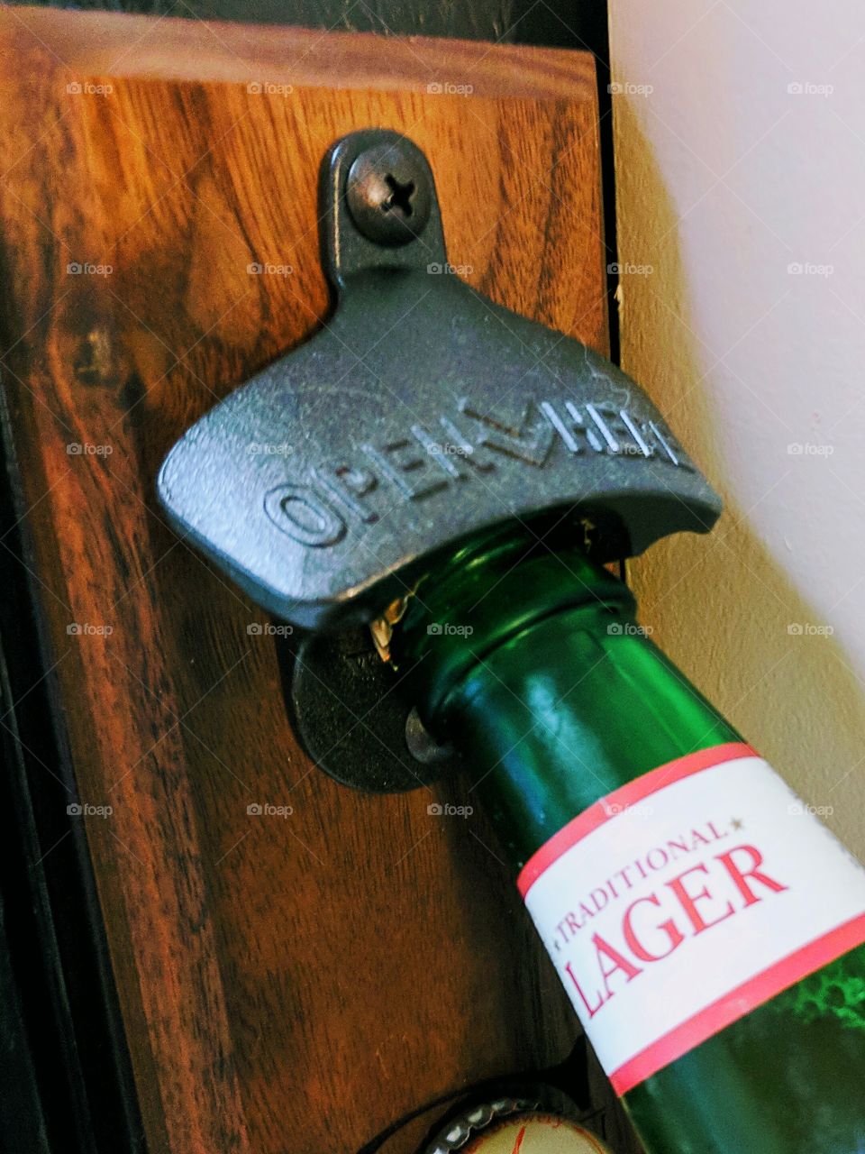 Opening a traditional lager beer bottle