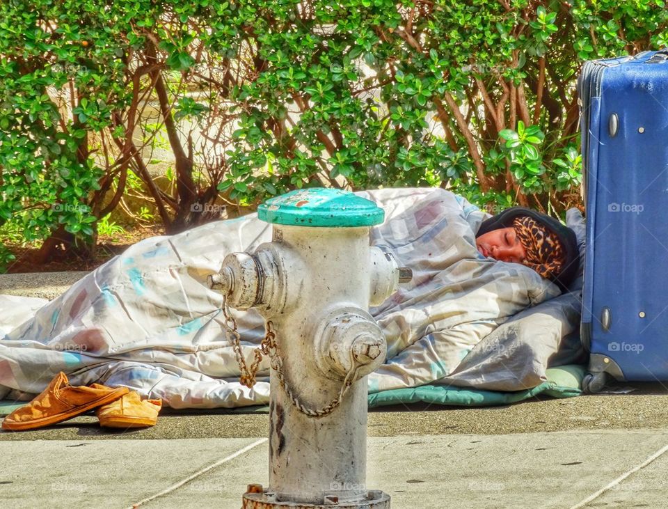 Homeless Woman Sleeping On A City Street. Homeless In America
