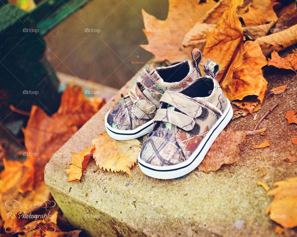 Baby shoes with autumn leafs