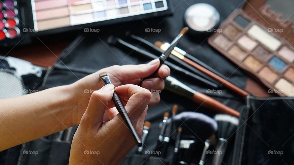 A woman applying make-up on hand