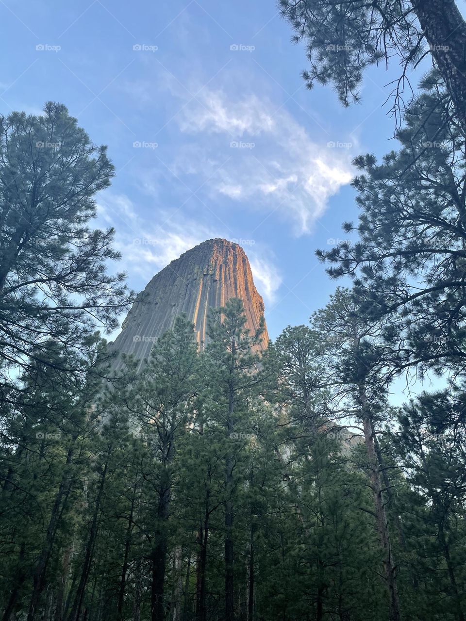 Devils Tower National Monument under wispy clouds