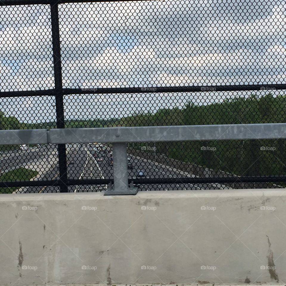 Beltway through fence card wall highway bridge view