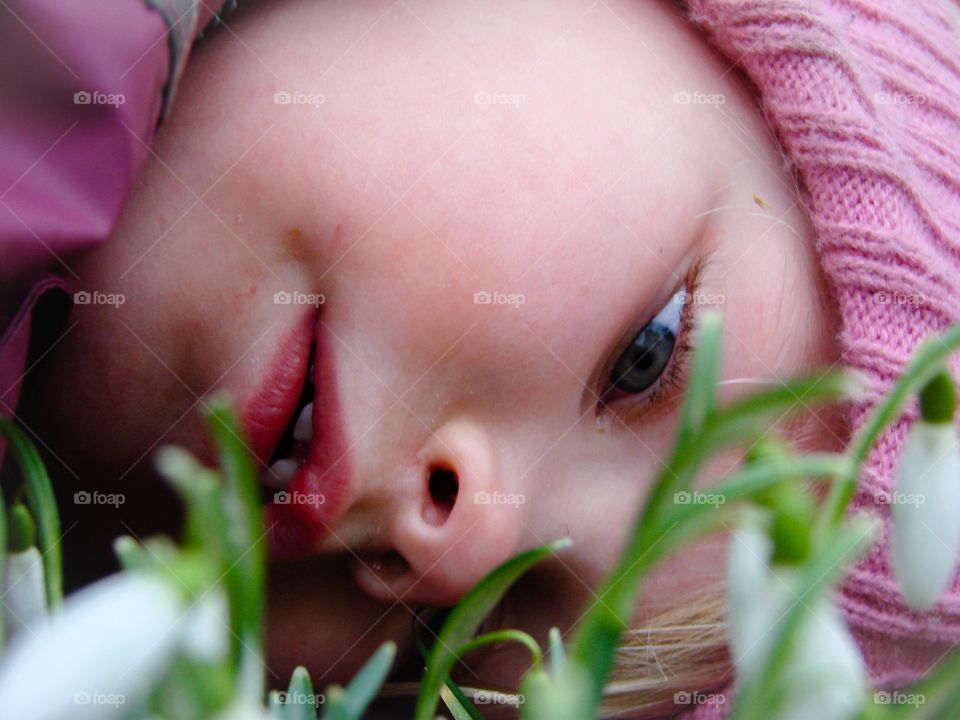 Girl. A girl is watching on the snowdrops 