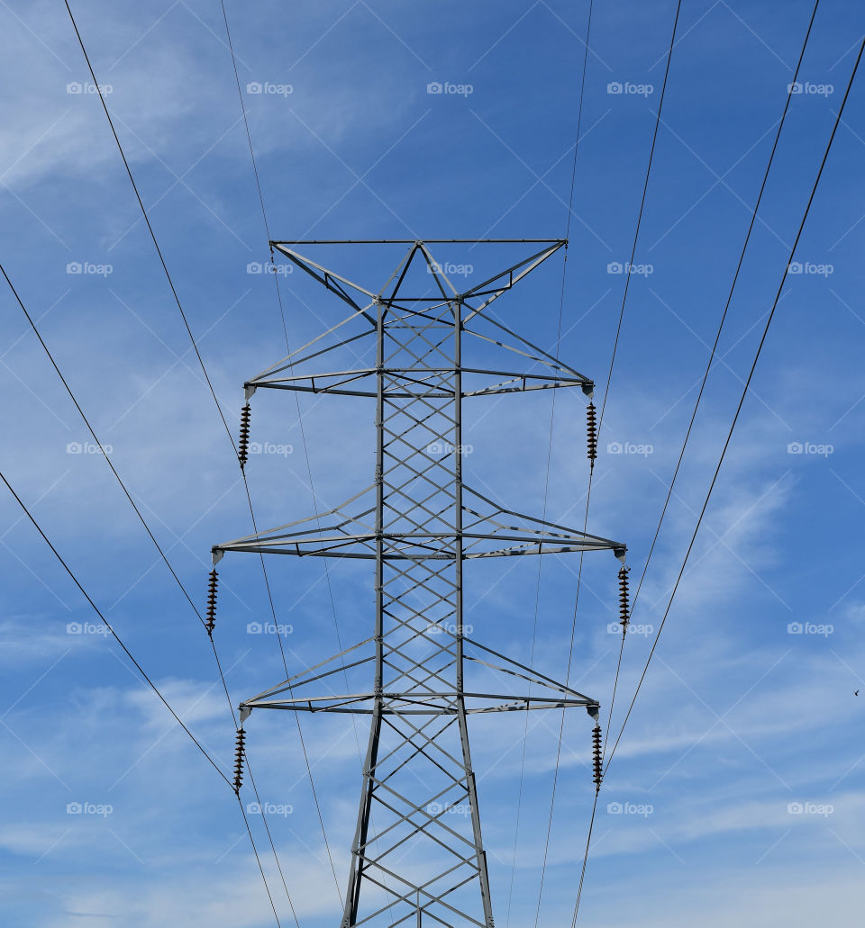 Electrical wires against a blue sky