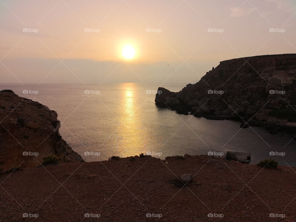 Sunset seen from a creek near the sea 