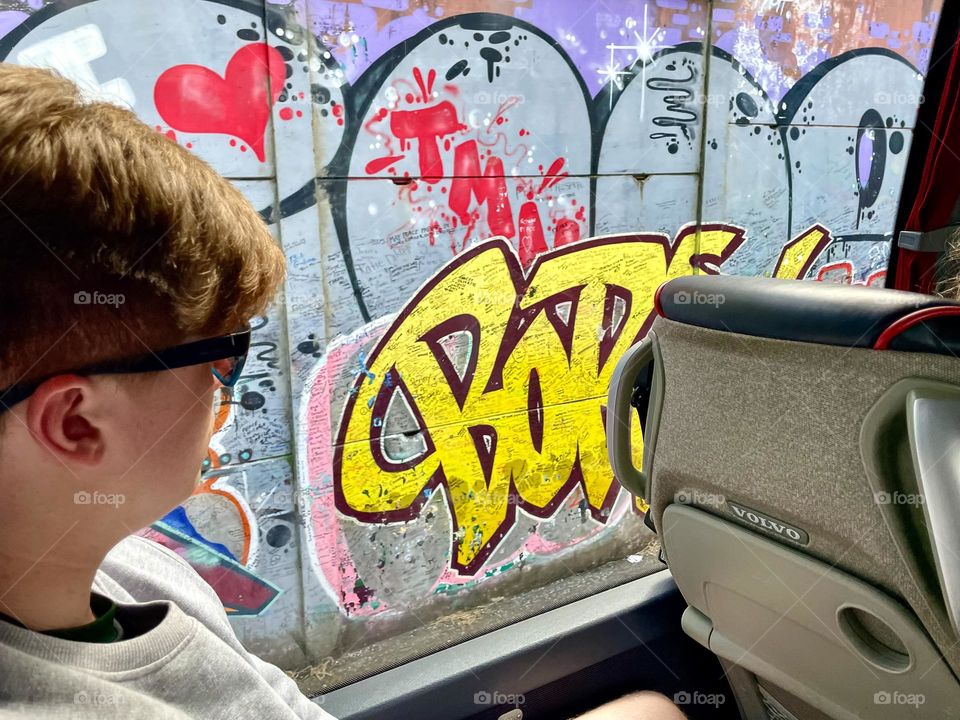 Vibrant urban street art seen through the window of a bus.