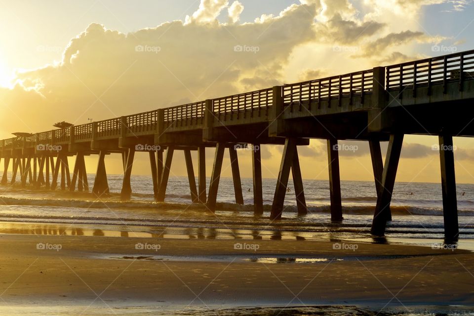 Pier at sunrise on the beach