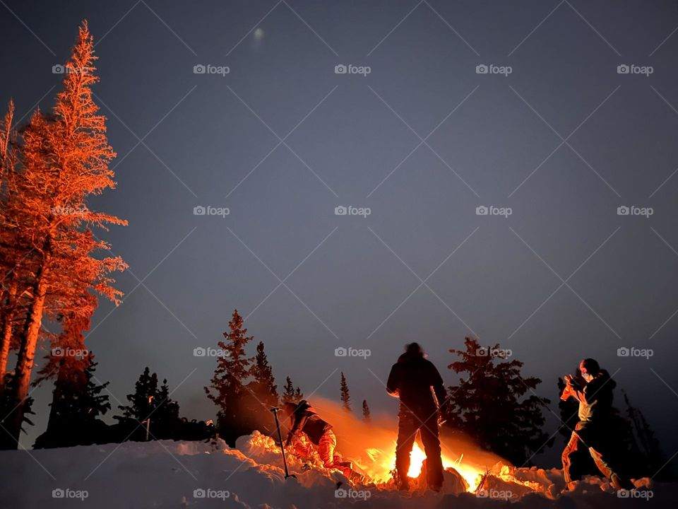 Bonfire picnic in the mountains, accessed by snowmobiles 