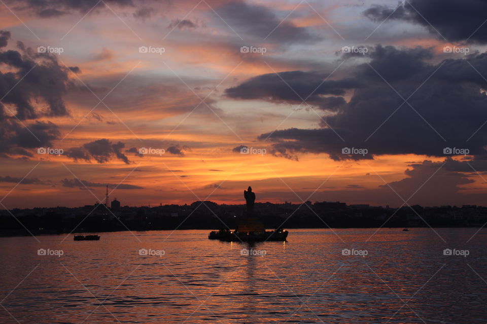 Sunset at lake view, Budha statue in water