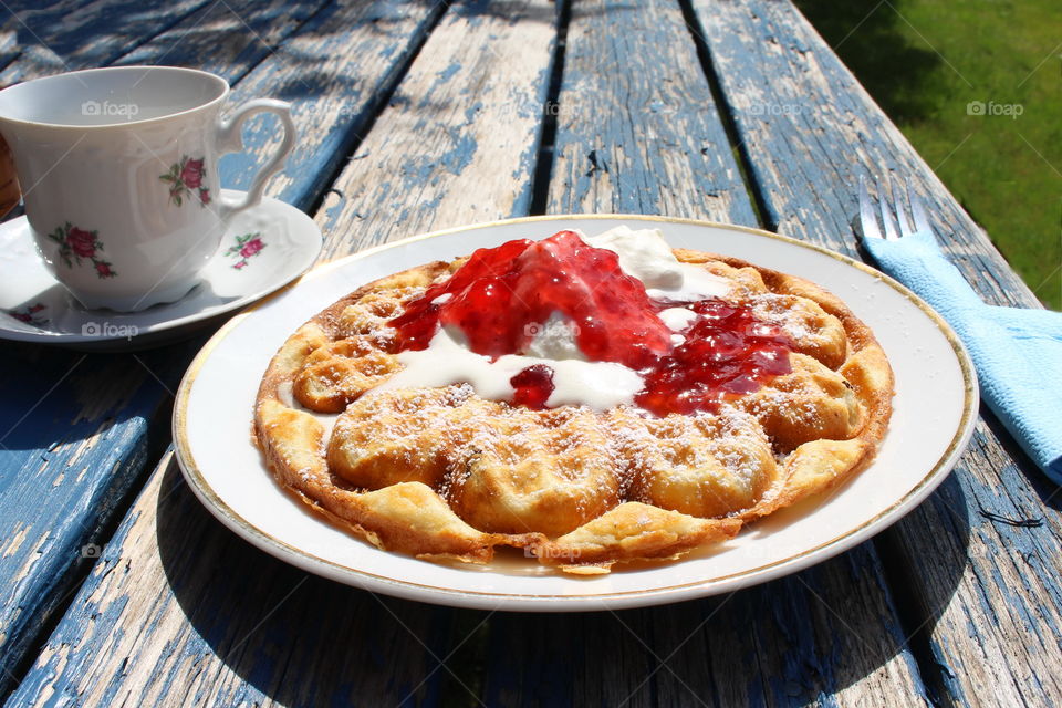 Waffle with jam and whipped cream