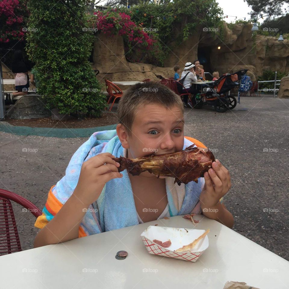 Boy eating meat