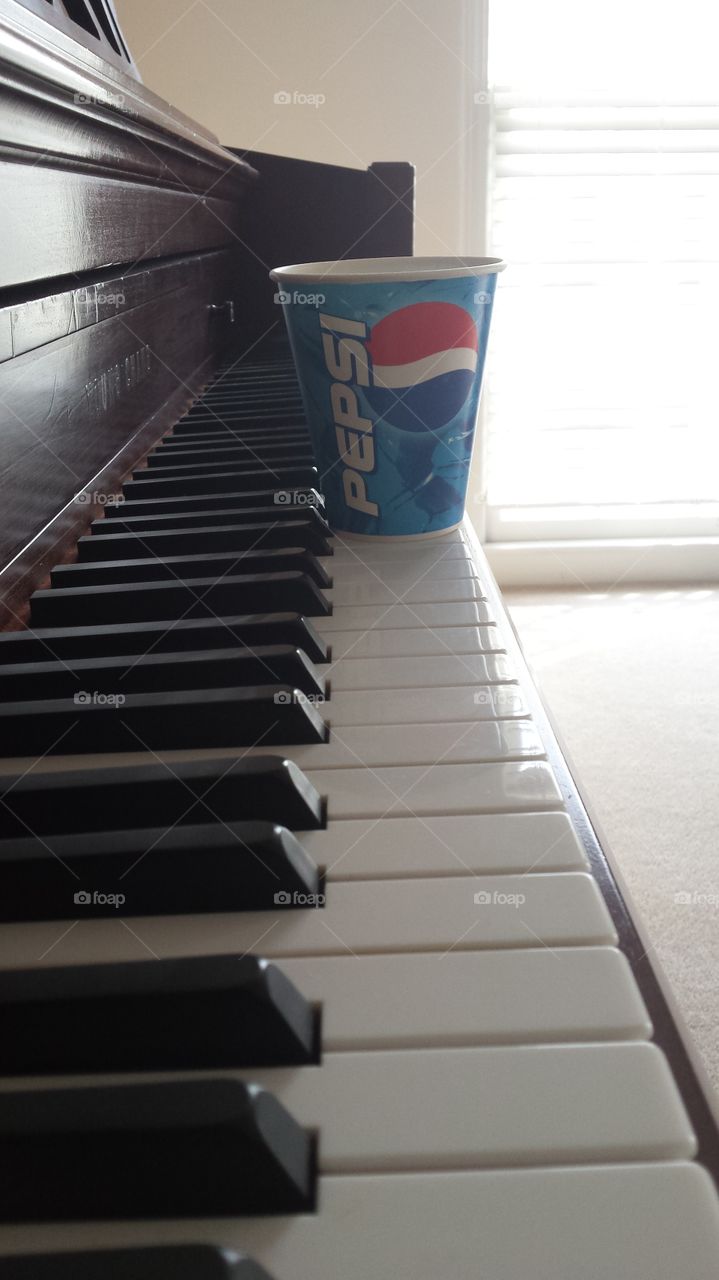 Pepsi on piano top wooden