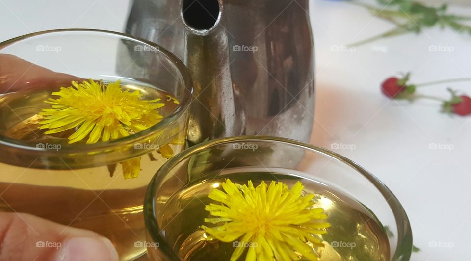 Close-up of tea with yellow dandelion