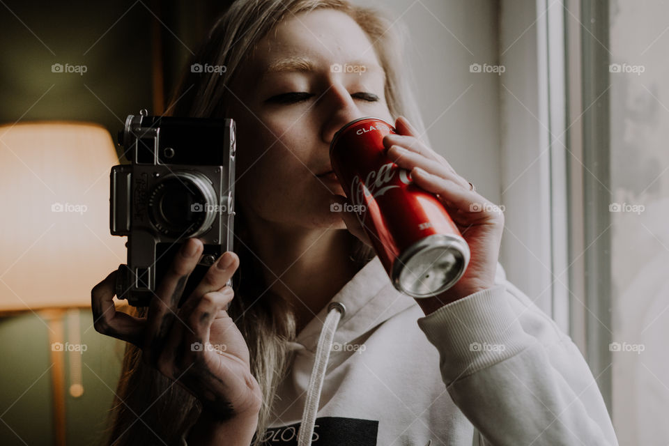 girl with a camera and coca cola