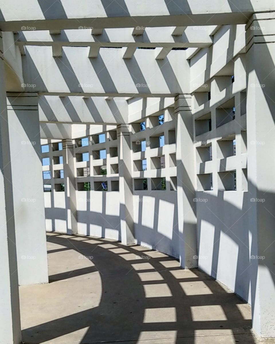 Shadows cast on ground inside white structure outside at Dealey Plaza in Dallas