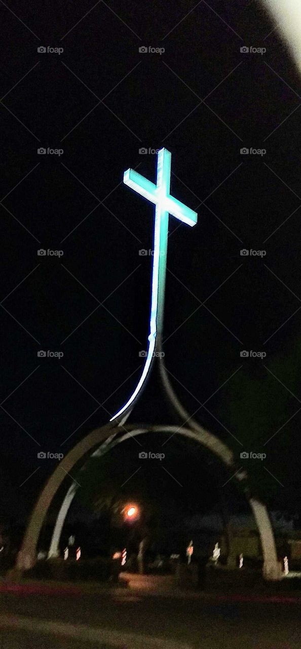 Cross on domed roof of church is blanketed with pure white light that can be seen for miles